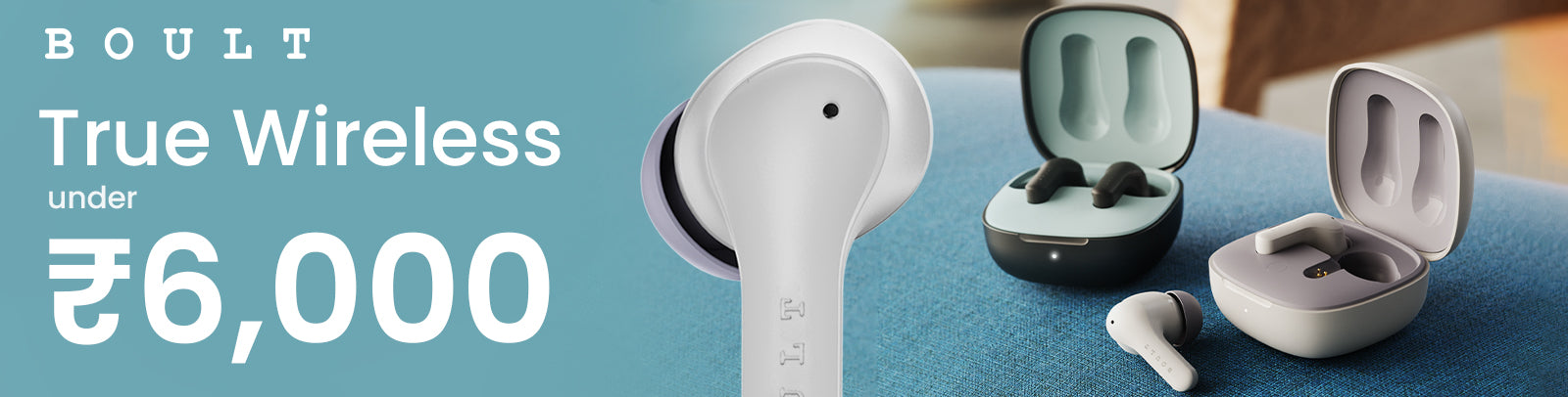 earbuds under 6000 with sleek designs in black and gray charging cases, placed on a fabric surface.